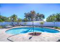 Kidney-shaped pool with surrounding patio and lush tropical landscaping at 9252 81St Ave, Seminole, FL 33777