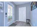 Bright entryway with glass front door, coat closet, and small table at 9252 81St Ave, Seminole, FL 33777