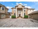 Two-story home with grand entrance, columns and paved driveway at 667 Richmond Close, Tarpon Springs, FL 34688