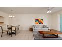 Open-concept living room with a ceiling fan, tile floors, and seating area including a view of the dining area at 7979 Sailboat Key S Blvd # 506, South Pasadena, FL 33707