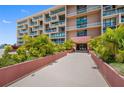 Condo building exterior, showing entrance and landscaping at 1 Key Capri # 102E, Treasure Island, FL 33706