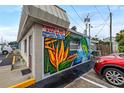 Commercial building with vibrant mural and ample parking at 800 Pasadena S Ave, St Petersburg, FL 33707