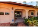 Front entry with a covered porch and brick walkway at 165 97Th Ne Ave, St Petersburg, FL 33702