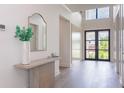 Bright and airy entryway with light wood flooring and a console table at 1254 Cordova Ne Blvd, St Petersburg, FL 33704
