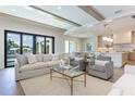 Bright living room features a comfy sofa, accent chairs, and large windows at 1254 Cordova Ne Blvd, St Petersburg, FL 33704