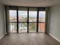 Living room with sliding doors and waterfront view at 255 Dolphin Pt # 809, Clearwater, FL 33767