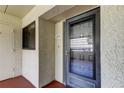 Condo entrance with updated door and security screen at 9490 Harbor Greens Way # 205, Seminole, FL 33776