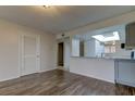 Living room with wood-look floors and access to kitchen at 9490 Harbor Greens Way # 205, Seminole, FL 33776
