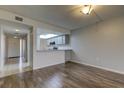 Open living area with wood-look floors and kitchen at 9490 Harbor Greens Way # 205, Seminole, FL 33776