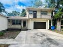 House exterior featuring a two-story home with a balcony and attached garage at 2811 Valencia S Way, St Petersburg, FL 33705