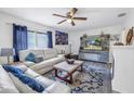 Bright living room with comfy seating, a fireplace, and a large TV at 5609 20Th S Ave, Gulfport, FL 33707
