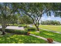 Landscaped grounds with a view of a golf course at 36750 Us Highway 19 N # 13202, Palm Harbor, FL 34684