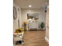 Whitewashed bench and dresser accent a spacious entryway at 36750 Us Highway 19 N # 21-302, Palm Harbor, FL 34684