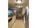 Well-lit kitchen with granite countertops and stainless steel appliances at 36750 Us Highway 19 N # 21-302, Palm Harbor, FL 34684