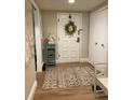 Bright entryway with decorative rug, bench, and wreath at 36750 Us Highway 19 N # 21-302, Palm Harbor, FL 34684