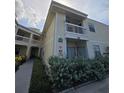 Charming condo with a balcony, featuring neat landscaping and a sidewalk leading to the building entrance at 6802 Stones Throw N Cir # 14206, St Petersburg, FL 33710