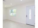 Bright and airy living room with tile floors and new door at 9197 79Th Ave, Seminole, FL 33777