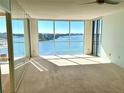Bright living room with floor-to-ceiling windows offering stunning water views at 100 Pierce St # 703, Clearwater, FL 33756