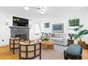 Bright living room features a fireplace, hardwood floors, and natural light from the large windows at 716 14Th Ne Ave, St Petersburg, FL 33701