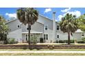 Two-story house with gray siding, landscaping, and brick wall at 577 Vista Trail Ct, Palm Harbor, FL 34683