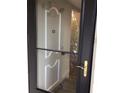 Condo building entry with black door and window at 1375 Doolittle Ln # 201, Dunedin, FL 34698