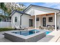 Backyard features a sparkling pool, lounge chairs and covered patio seating for outdoor relaxation at 316 11Th N Ave, St Petersburg, FL 33701