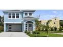 Charming two-story blue home featuring a covered carport, freshly manicured lawn, and modern architectural details at 4234 4Th S St, St Petersburg, FL 33705