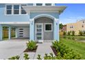 Home with front door, modern lighting, freshly landscaped yard, and covered carport at 4234 4Th S St, St Petersburg, FL 33705