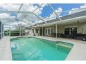 Inviting screened-in pool area with patio furniture and a covered lanai at 14088 Bruni Dr, Spring Hill, FL 34609