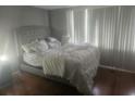 Simple bedroom with a bed and hardwood flooring at 7505 Pitch Pine Cir # 123, Tampa, FL 33617