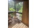 Screened porch with wooden chairs and partial plywood wall at 7505 Pitch Pine Cir # 123, Tampa, FL 33617