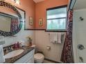 Bathroom with granite vanity and tiled shower at 18 Heilwood St, Clearwater Beach, FL 33767