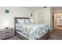 Cozy bedroom with a full bed, nightstand, and access to a bathroom at 1354 Azalea Dr # 1803, Dunedin, FL 34698
