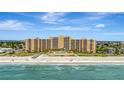 Stunning aerial view of beachfront building with pool at 880 Mandalay Ave # S206, Clearwater Beach, FL 33767