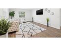 Bright living room featuring a cozy sitting area with stylish furniture, modern decor, and wood-look flooring at 508 Brooker Rd, Brandon, FL 33511