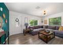 Spacious living room with sectional sofa and wood-look floors at 6199 59Th N Pl, St Petersburg, FL 33709