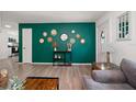 Bright living area with green accent wall and entryway view at 6199 59Th N Pl, St Petersburg, FL 33709