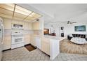 Galley kitchen with white appliances and hexagonal tile floor at 6269 Palma Del Mar S Blvd # 608, St Petersburg, FL 33715