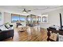 Living room with hardwood floors, sliding doors to balcony, and city views at 6269 Palma Del Mar S Blvd # 608, St Petersburg, FL 33715