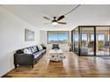 Bright living room with hardwood floors, balcony access, and city views at 6269 Palma Del Mar S Blvd # 608, St Petersburg, FL 33715