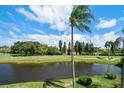 Scenic view of a peaceful waterway next to a lush golf course at 5700 Escondida S Blvd # 306, St Petersburg, FL 33715