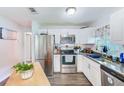 Modern kitchen featuring white cabinets, stainless steel appliances, and granite countertops at 6520 15Th N St, St Petersburg, FL 33702