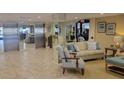 Building Lobby with seating and elevators at 1651 Sand Key Estates Ct # 74, Clearwater Beach, FL 33767