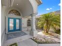 Inviting entryway with double teal doors and arched detail at 7162 Benson St, Englewood, FL 34224