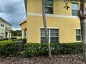 Yellow two-story townhouse exterior at 9749 Trumpet Vine Loop, Trinity, FL 34655