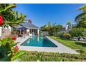 Relaxing backyard oasis with a sparkling pool and patio seating area at 366 6Th N Ave, Tierra Verde, FL 33715
