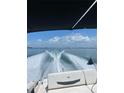 Open boat cruising with a wake, showing the experience of recreational activities and waterfront living at 440 64Th Ave, St Pete Beach, FL 33706