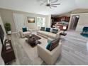 Bright and airy living room featuring a comfortable seating arrangement and kitchen views at 1495 Robwood Ter, North Port, FL 34288