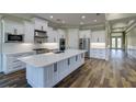 Modern kitchen with white cabinets, large island, and stainless steel appliances at 241 5Th N Ave, Safety Harbor, FL 34695