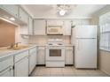 Efficient kitchen with white cabinets and appliances at 4244 Tamargo Dr, New Port Richey, FL 34652